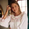 Samantha Varvel x Smock London Women's Nightingale Dress Moonstone White with Candy Cane Trim and Holly Hand Smocking sold by Smock London