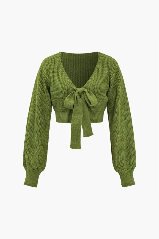 Solid strik skåret ud bue langærmet top sold by Micas