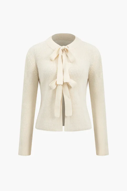 Solid strik tie-up cardigan sold by Micas