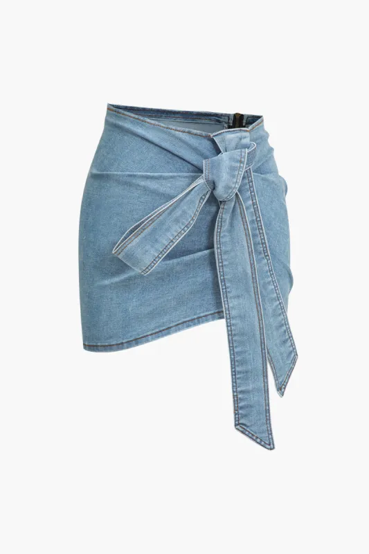 Denim asymmetrisk bue nederdel sold by Micas