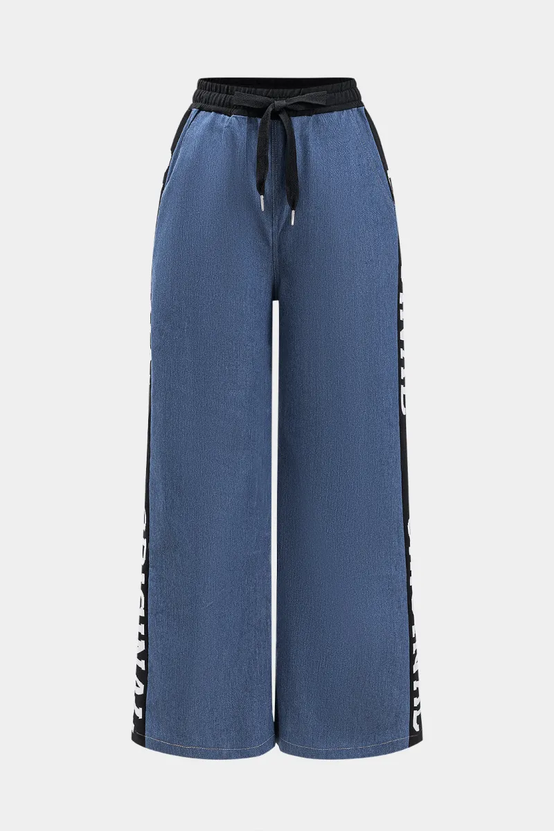 Brevprint denim plisseret slips foran patchwork brede ben bukser sold by Micas