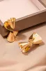 Twisted Metallic Surface Earring sold by Micas