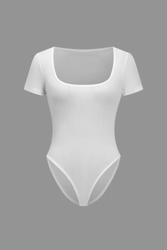 Grundlæggende solid bodysuit sold by Micas