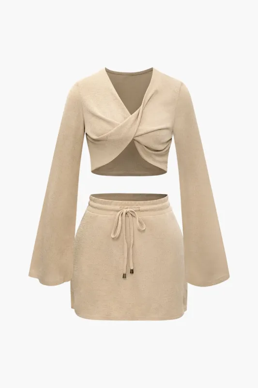 V-neck Twist Bell Sleeve Top And Tie Waist Mini Skirt Set sold by Micas
