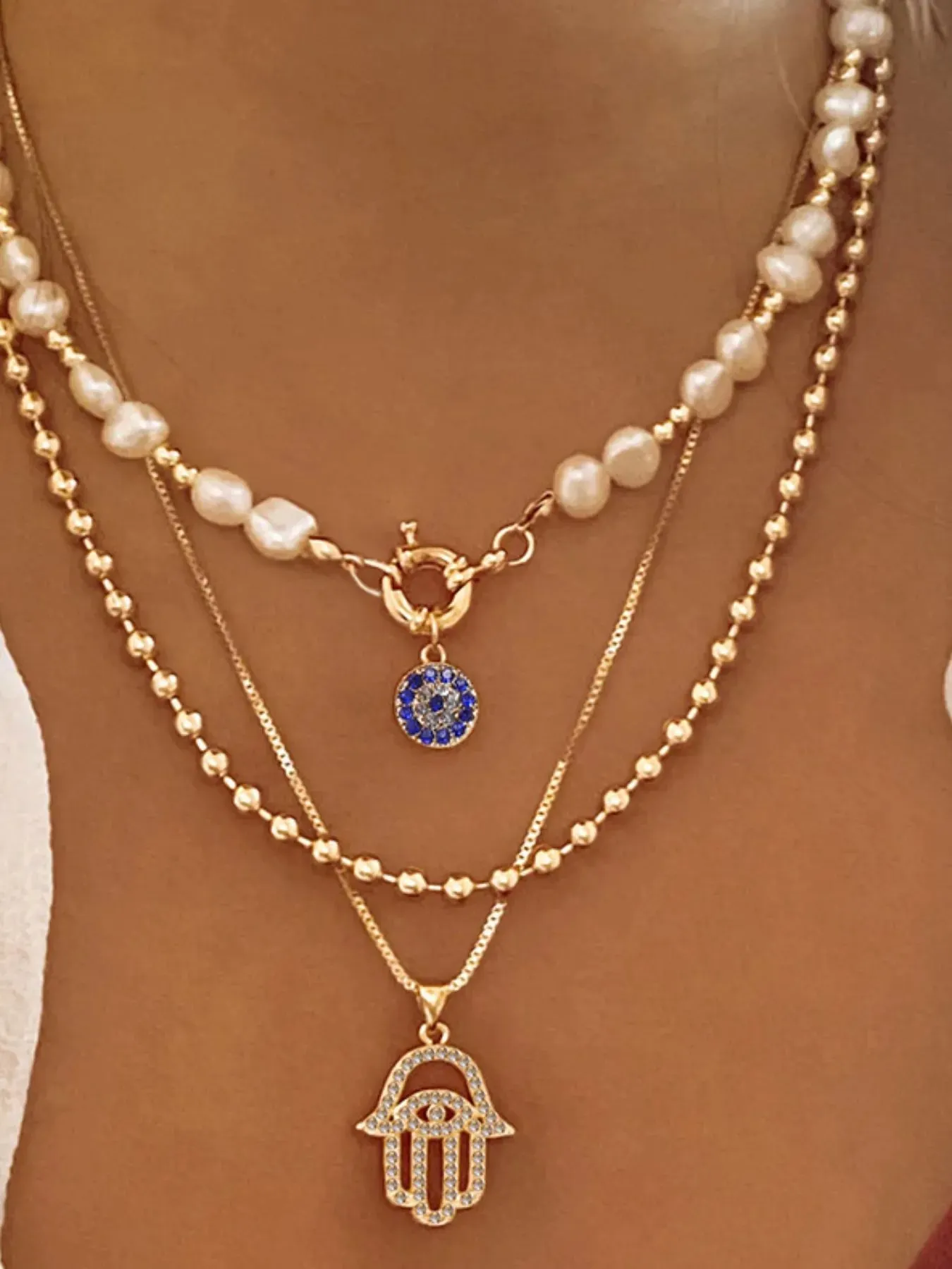 Layered Pearl Chain Evil Eye Hamsa Pendant Necklace sold by Gigi Laurent