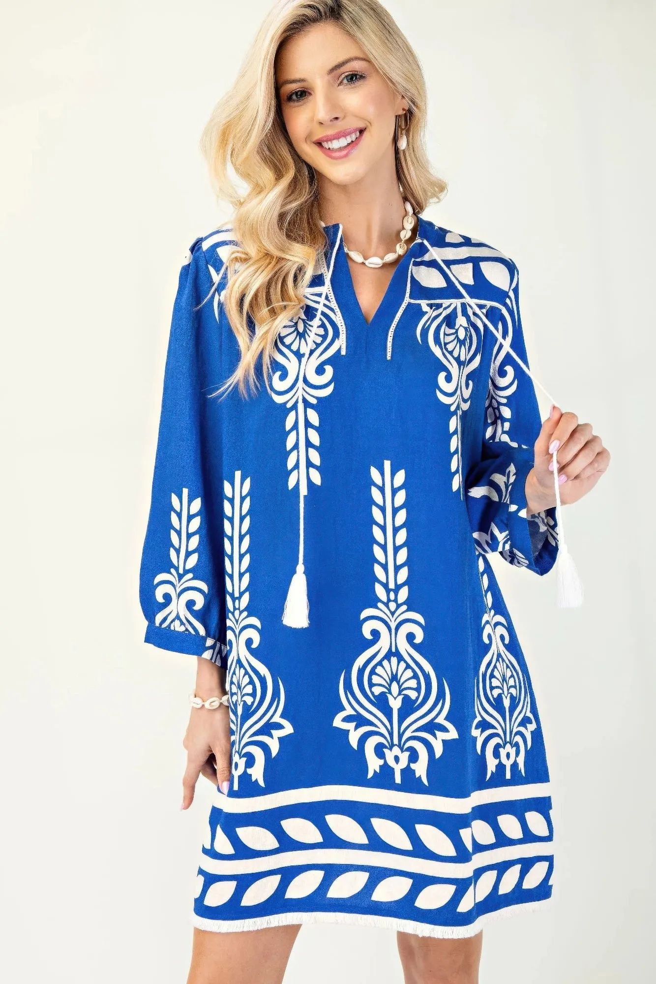 Printed 3/4 Sleeve Dress With Tassel Tie And Fringe Detail On Hem sold by Gigi Laurent