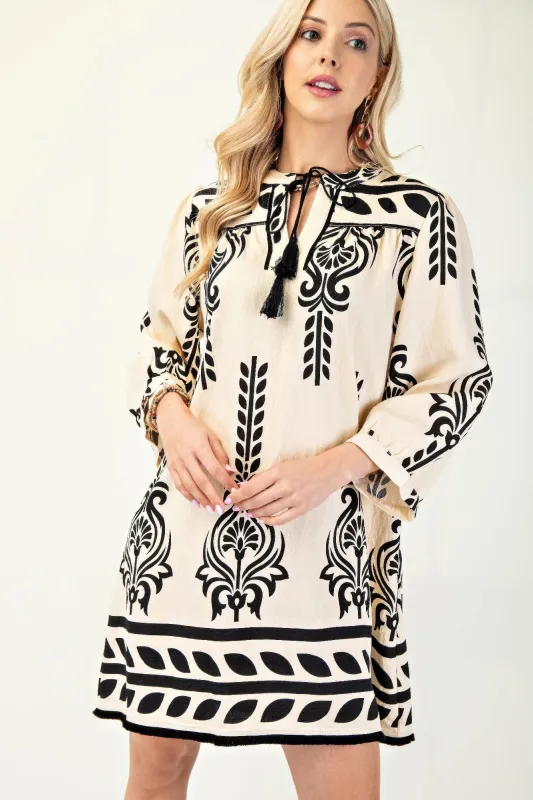 Printed 3/4 Sleeve Dress With Tassel Tie And Fringe Detail On Hem sold by Gigi Laurent