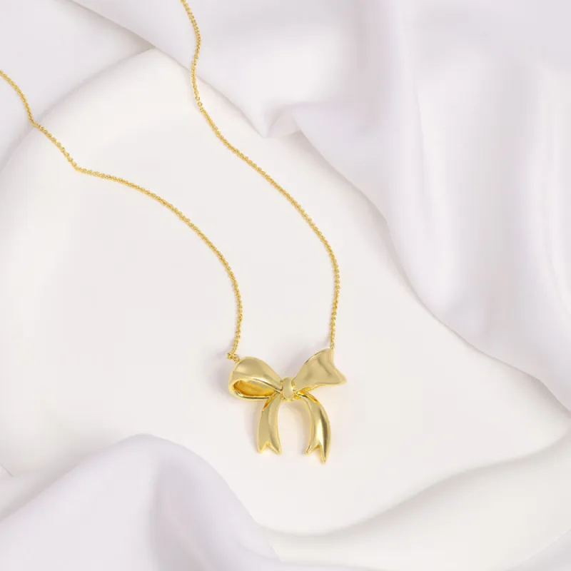 Bow Gold Necklace sold by Wanderlust and Co