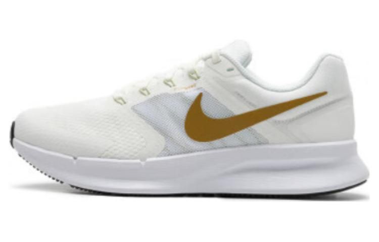 white and gold nike running shoes