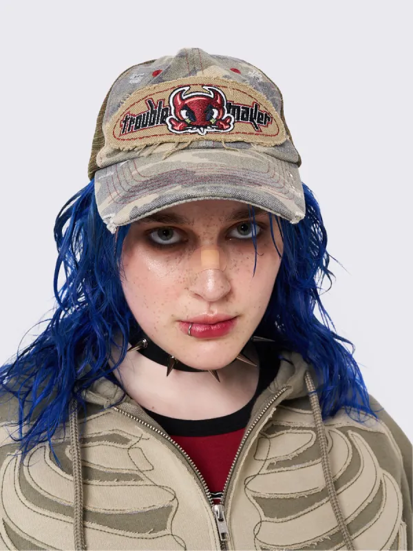 Troublemaker Camo Distressed Trucker Hat sold by Minga London