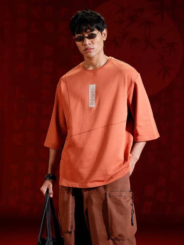 Men’s oversized 3/4 sleeve T-shirt with chest print & tonal stich detail | Rust sold by Wrogn