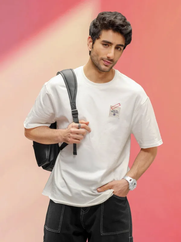 Solid Oversized T-Shirt With Printed Canvas Patch And Raw Edge Detail  | Off White sold by Wrogn