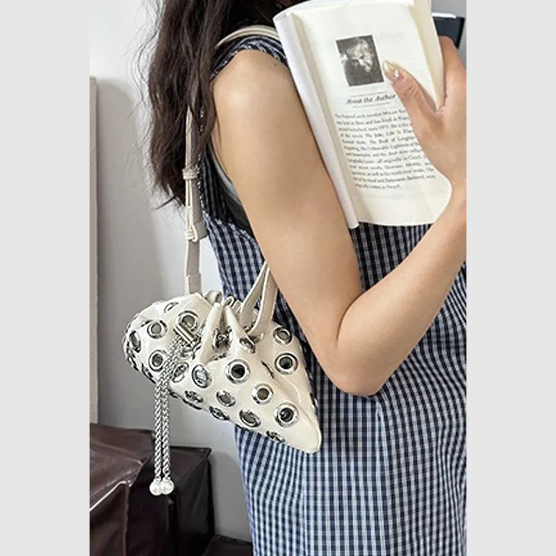 Sally Metal Eyelet Shoulder Bag With Drawstring Fastening in Beige sold by XYlondon