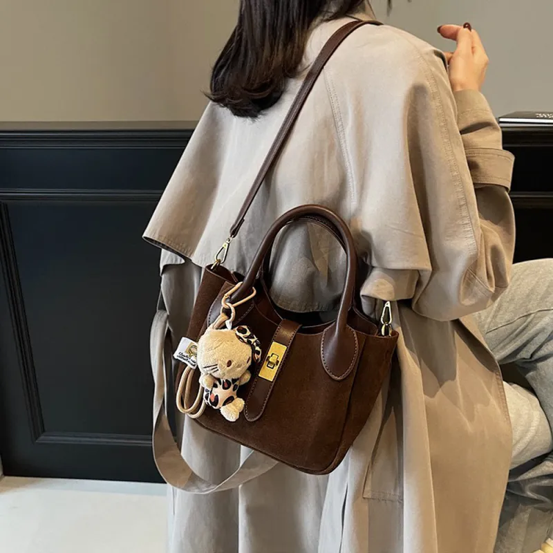 Nicole Crossbody Shoulder Tote Bag With Gold Buckle and Bag Charm in Brown Faux Suede sold by XYlondon