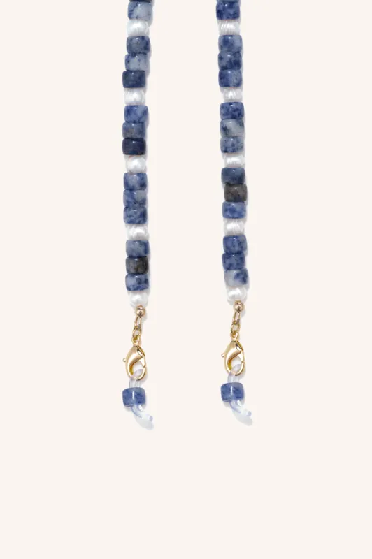 gem + pearl mask/sunny chain sold by DONNI.