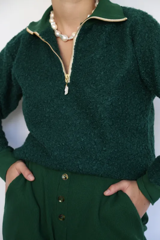 curly 1/2 zip pullover sold by DONNI.