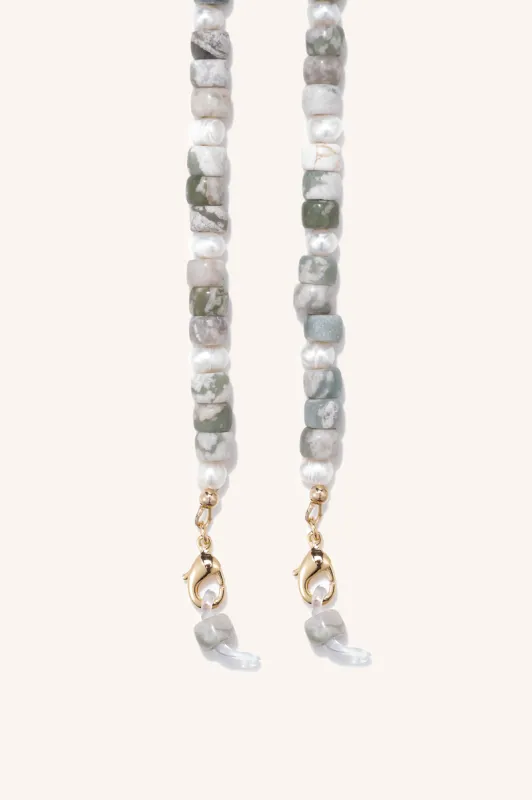 gem + pearl mask/sunny chain sold by DONNI.