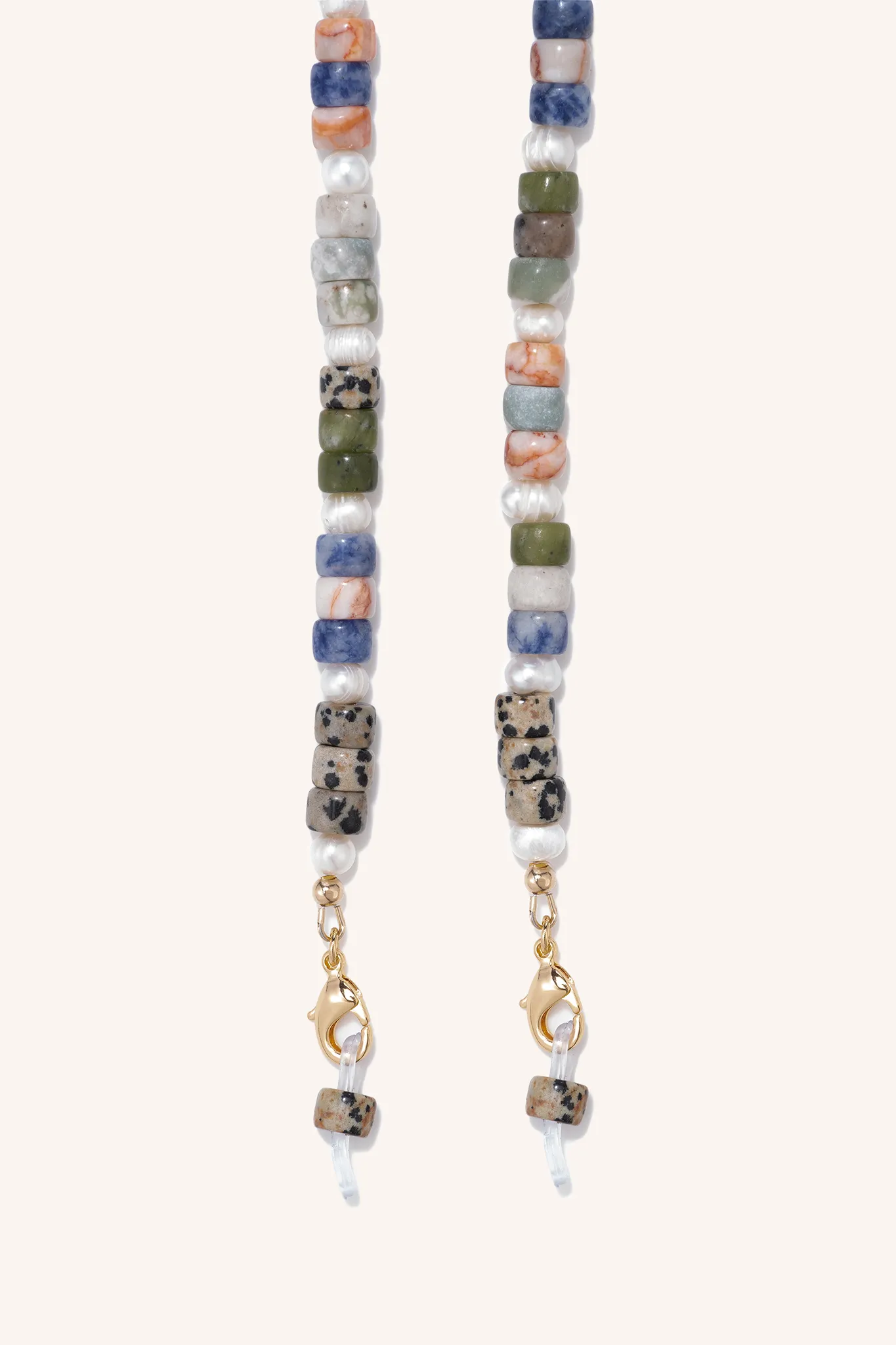 gem + pearl mask/sunny chain sold by DONNI.