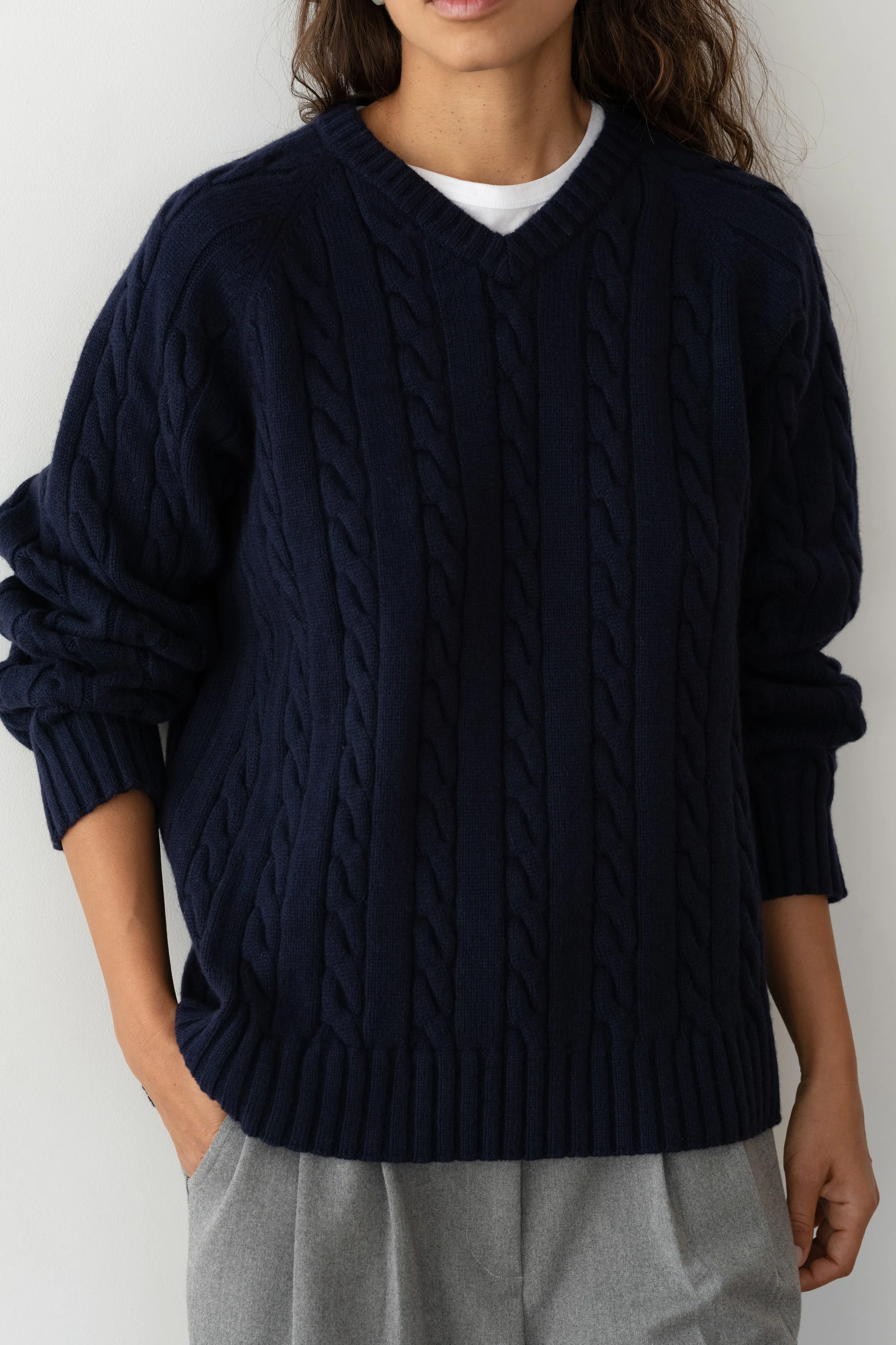 The Cable V-Neck Sweater sold by DONNI.