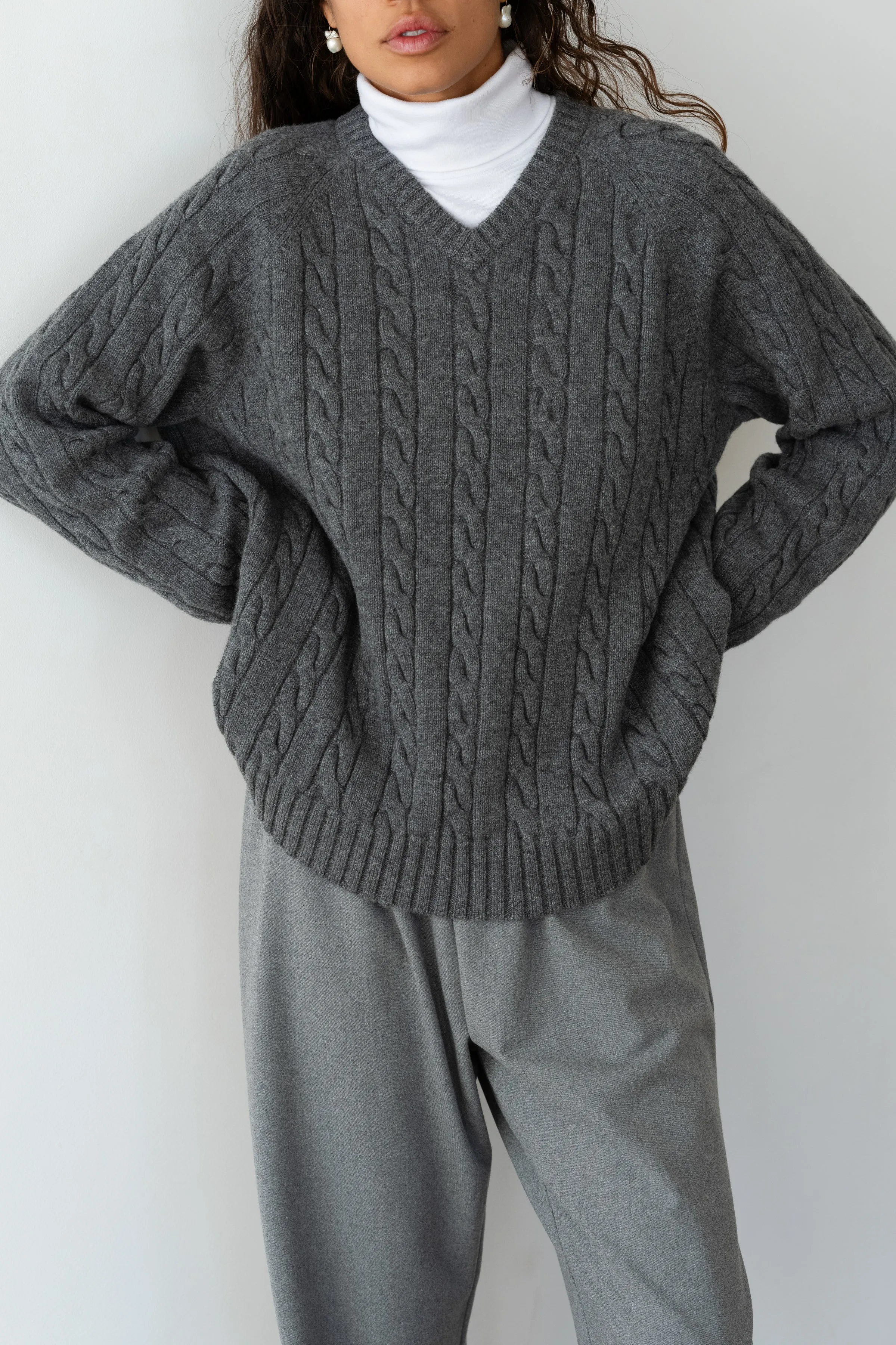 The Cable V-Neck Sweater sold by DONNI.