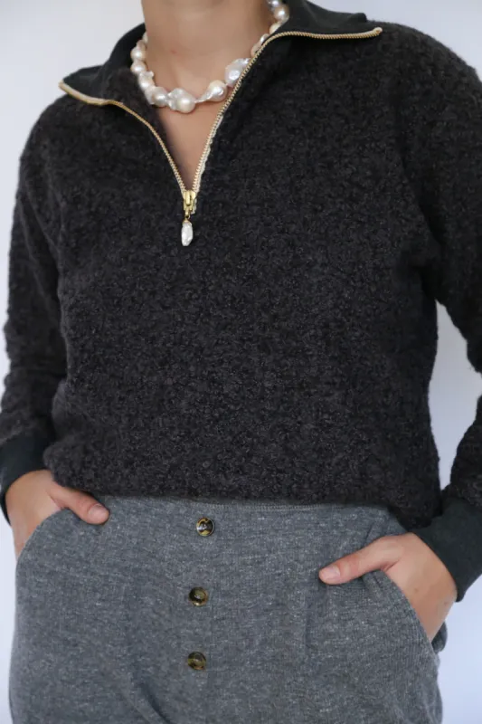 curly 1/2 zip pullover sold by DONNI.