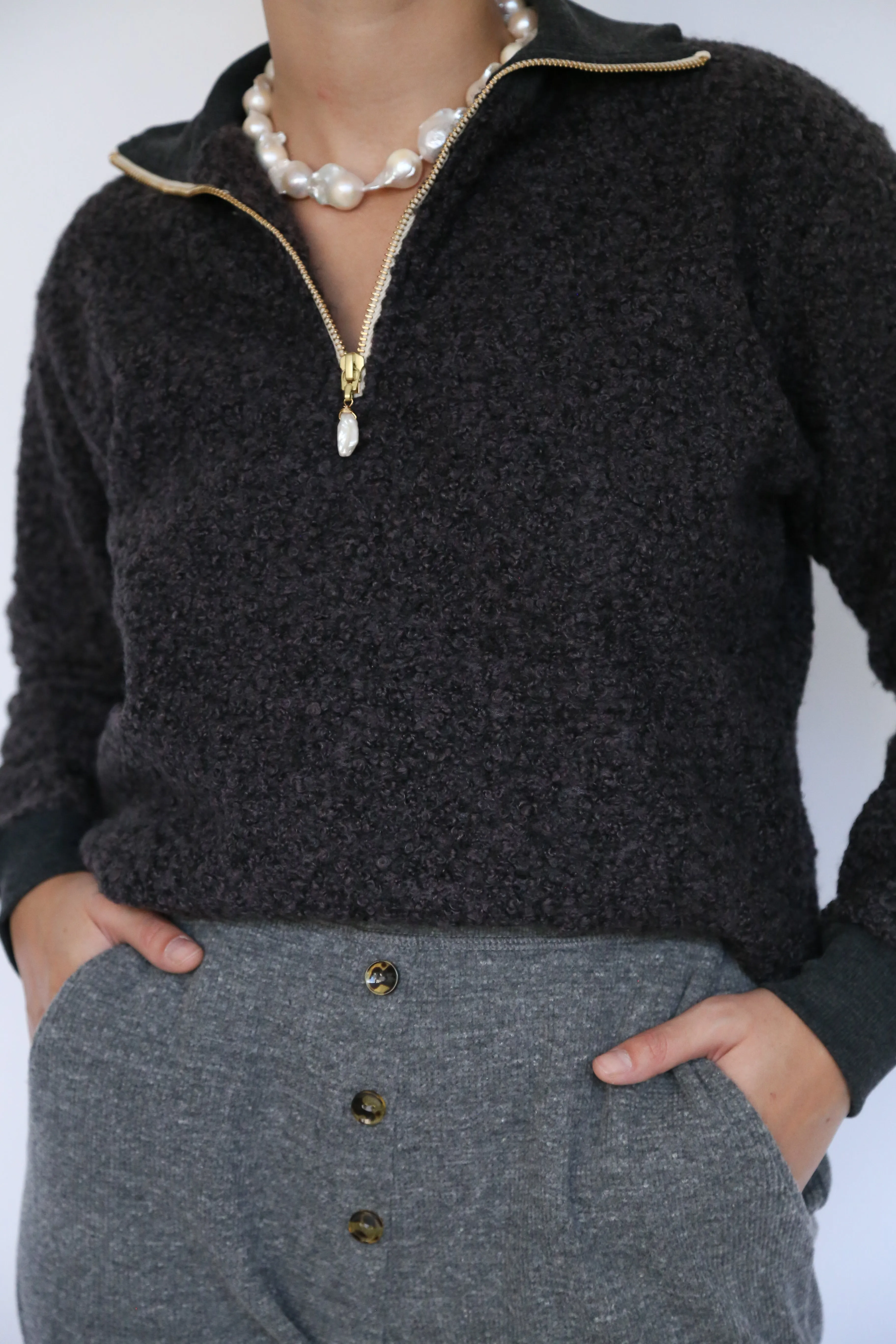 curly 1/2 zip pullover sold by DONNI.