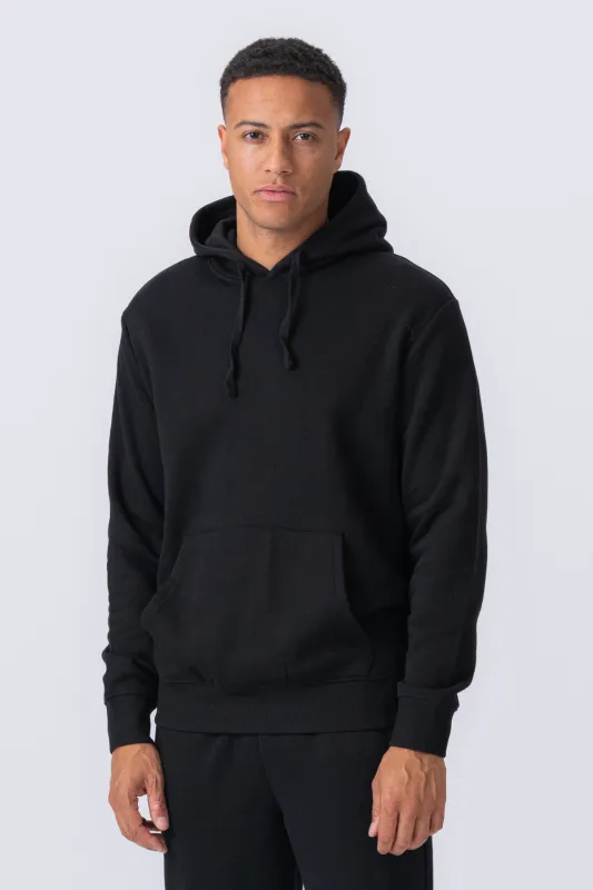 Essential Hoodie - Sort sold by Teeshoppen