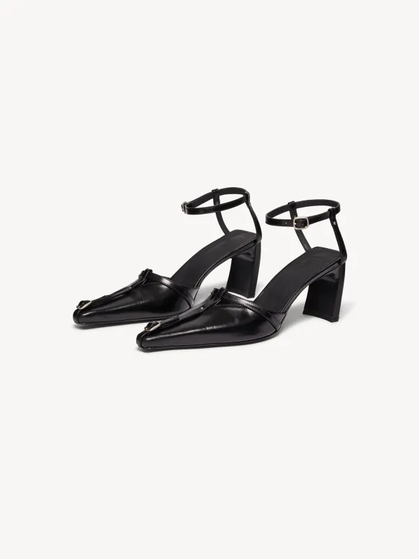 Serpent Buckle Mules Black sold by KNWLS
