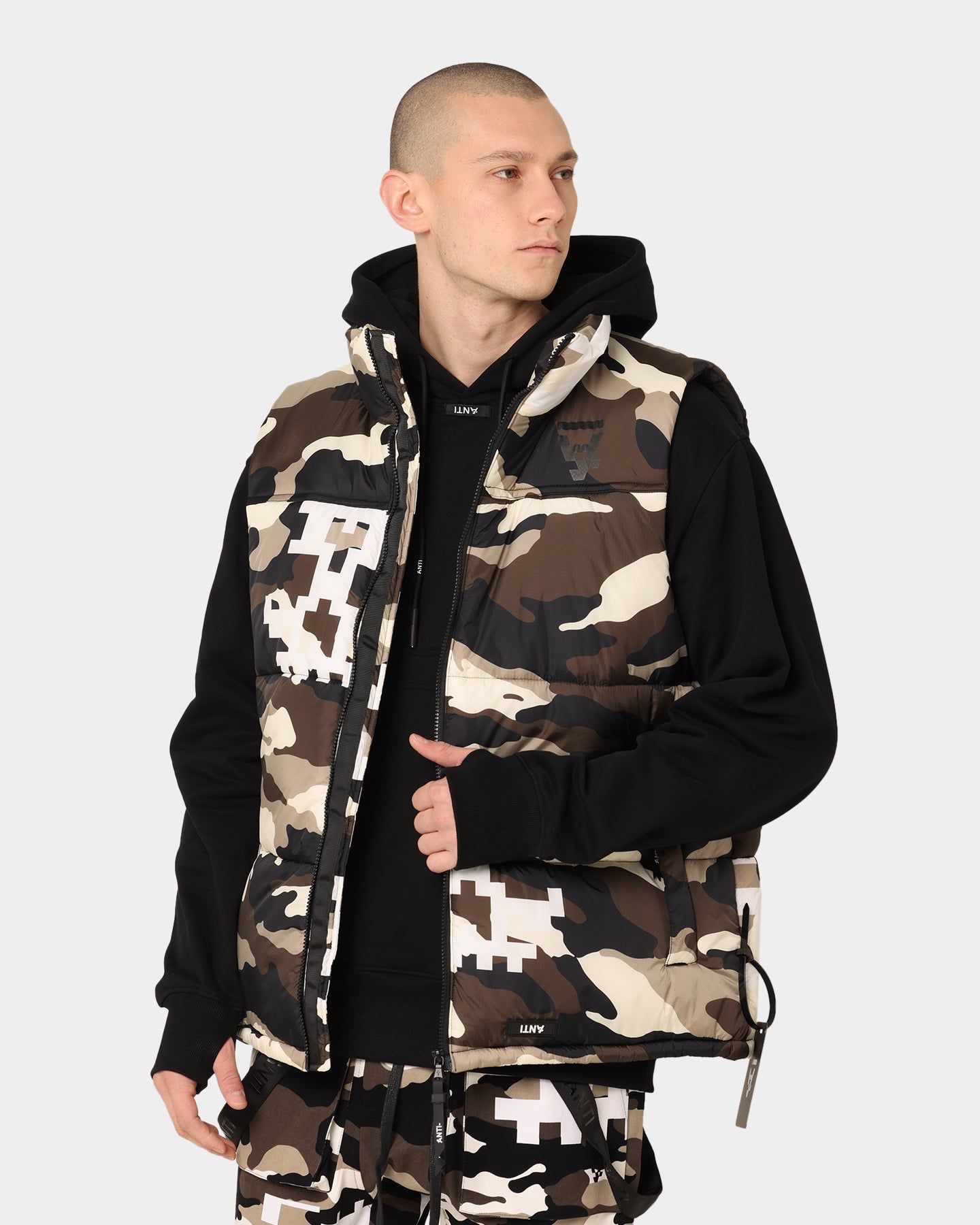 The Anti-Order Dead Pixel Puffer Vest Brown/White/Black Camo sold by Culture Kings