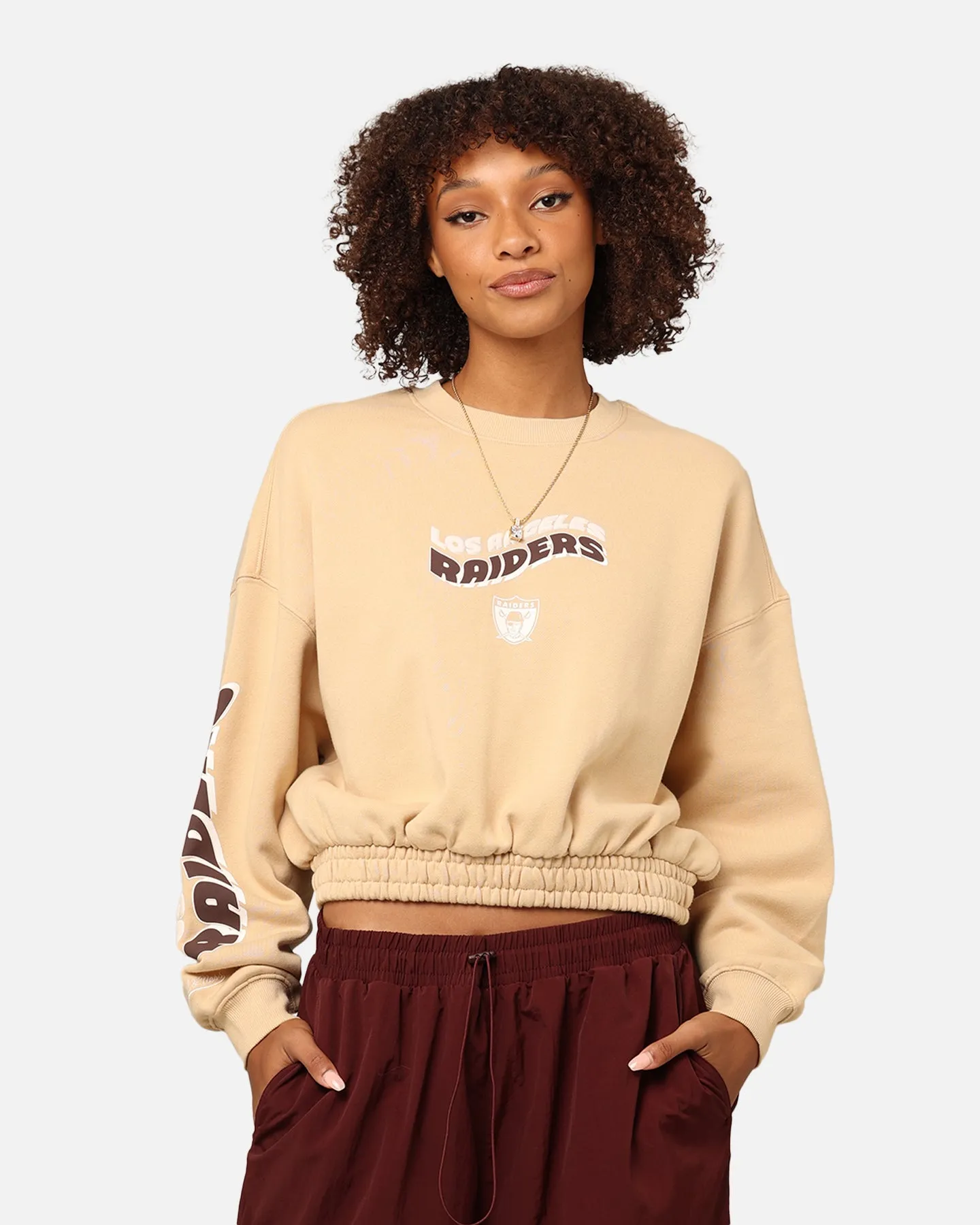 Mitchell & Ness Women's Los Angeles Raiders Dazed Cropped Crewneck Warm Sand sold by Culture Kings