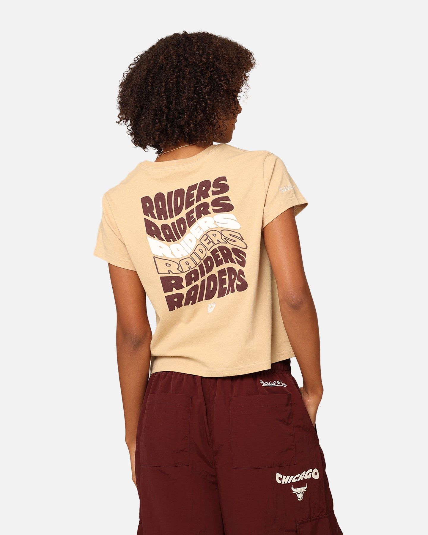 Mitchell & Ness Women's Los Angeles Raiders Wavey Text Shrunken Baby T-Shirt Warm Sand sold by Culture Kings