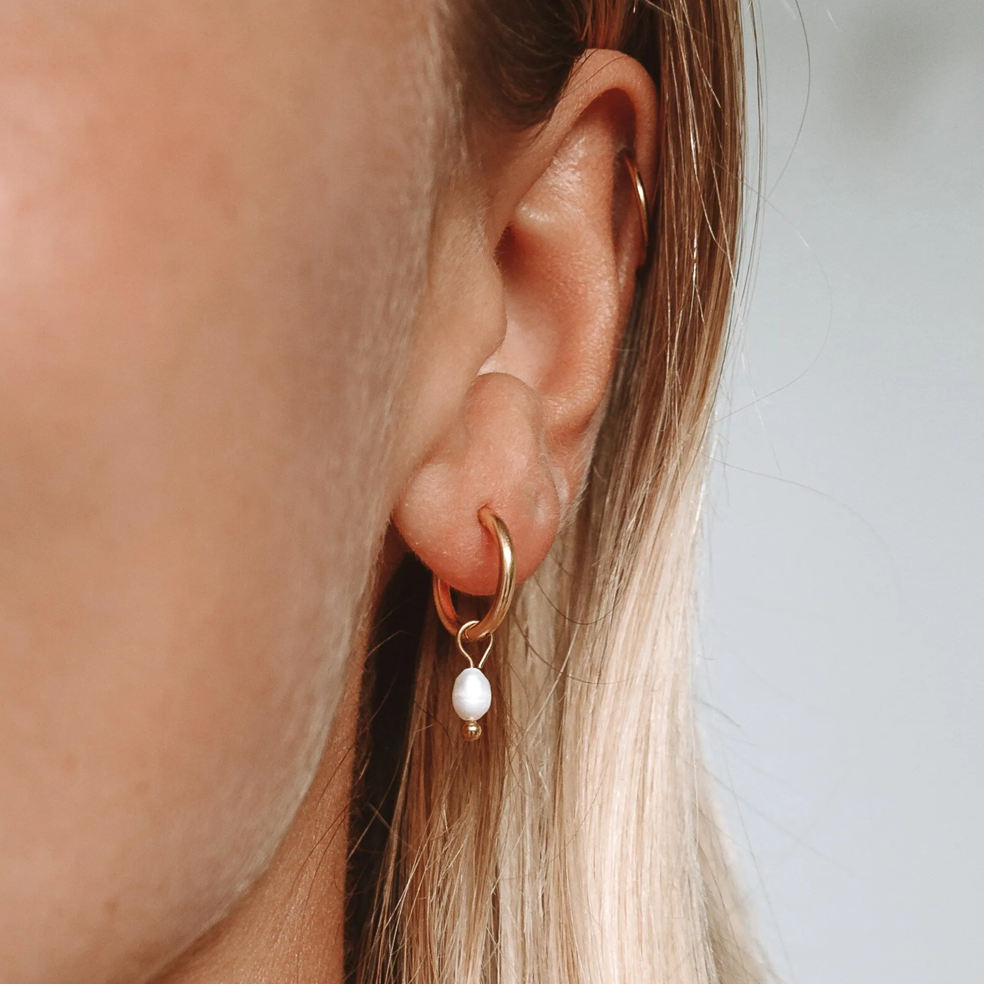 Pearl Huggie Hoops sold by Atolea