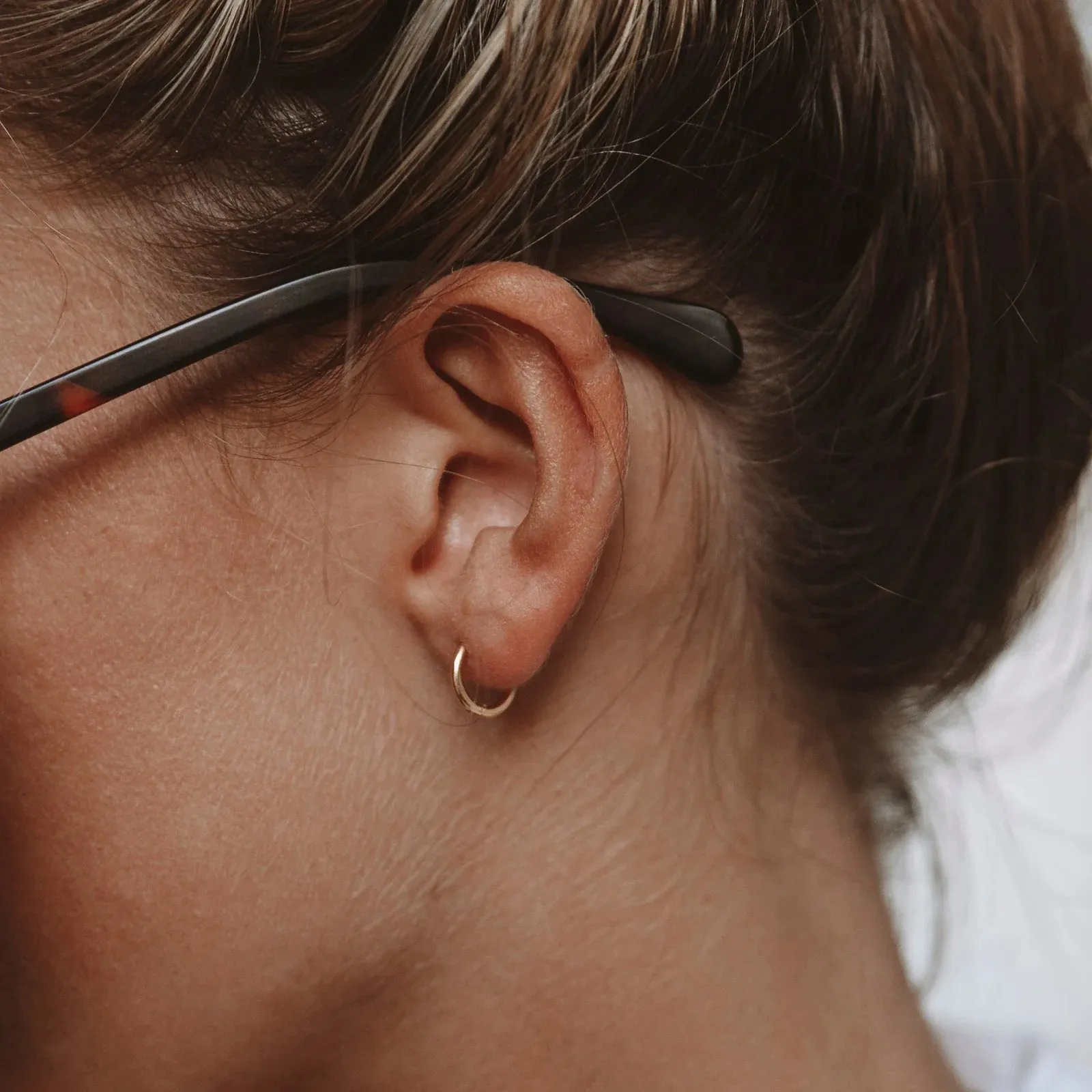 Tiny Huggie Hoops sold by Atolea