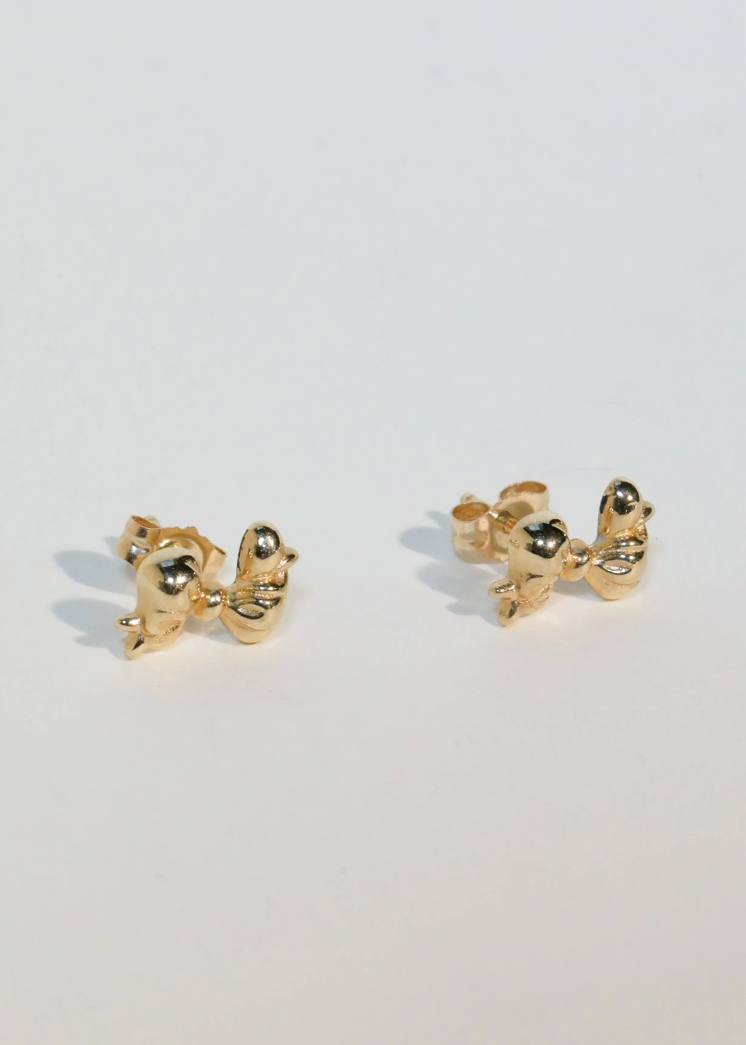 Archive Mini Bow Studs in 14k sold by Mondo Mondo