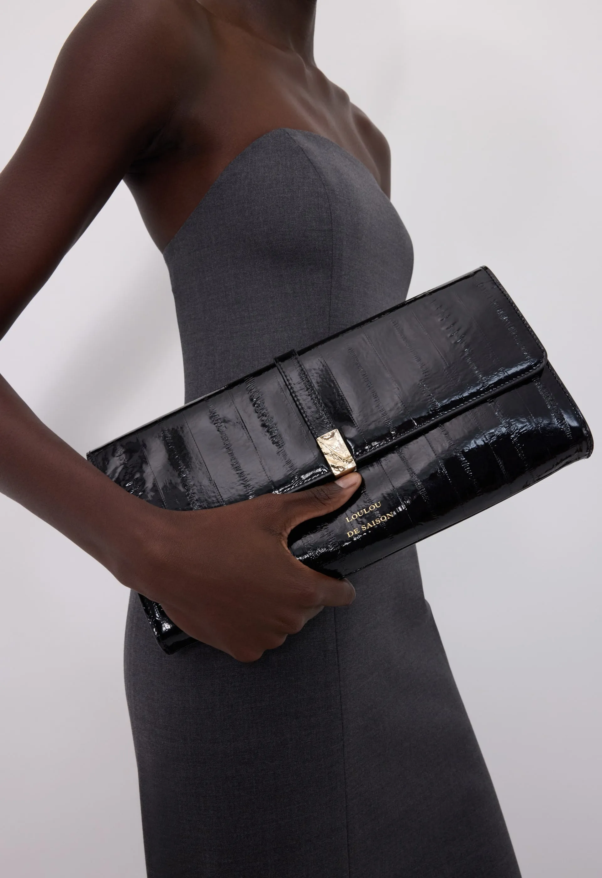 LYDIAN Eel-effect leather clutch sold by Loulou De Saison