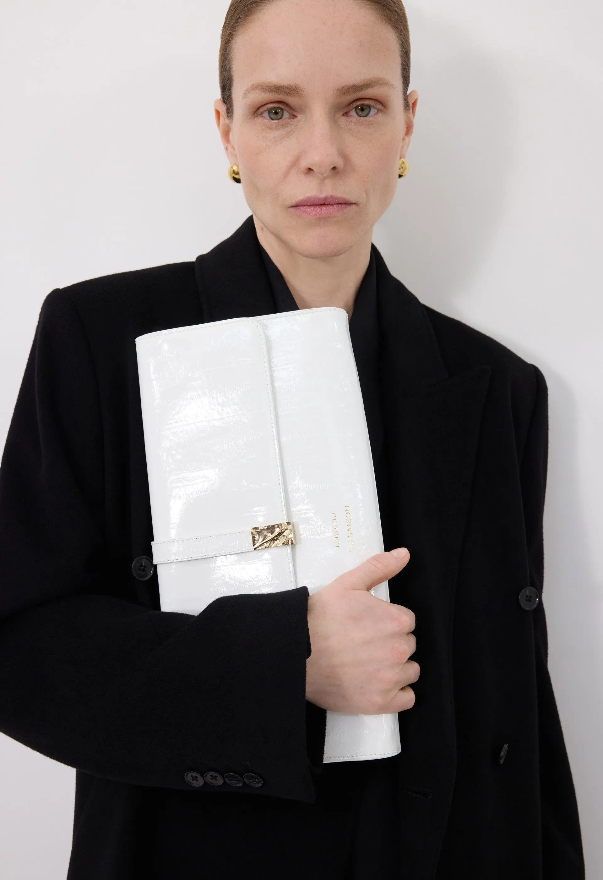LYDIAN Eel-effect leather clutch sold by Loulou De Saison