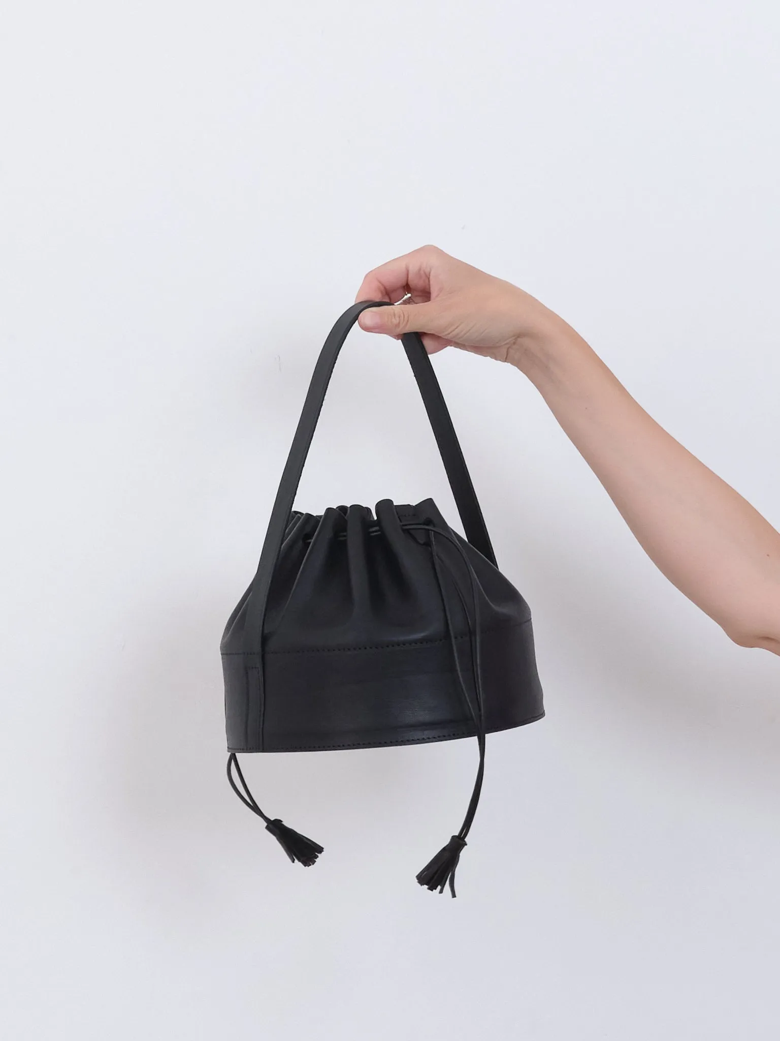 LEATHER DRAWSTRING COLLAR BAG sold by Cawley