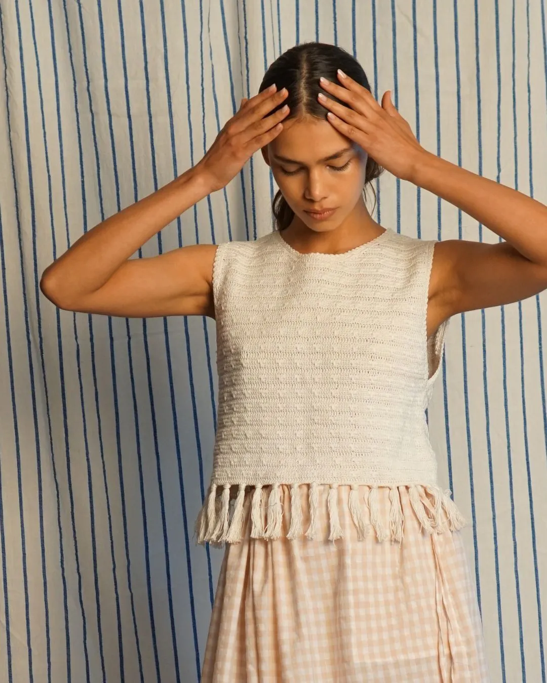 Fringe hem crochet vest sold by Proche Studio