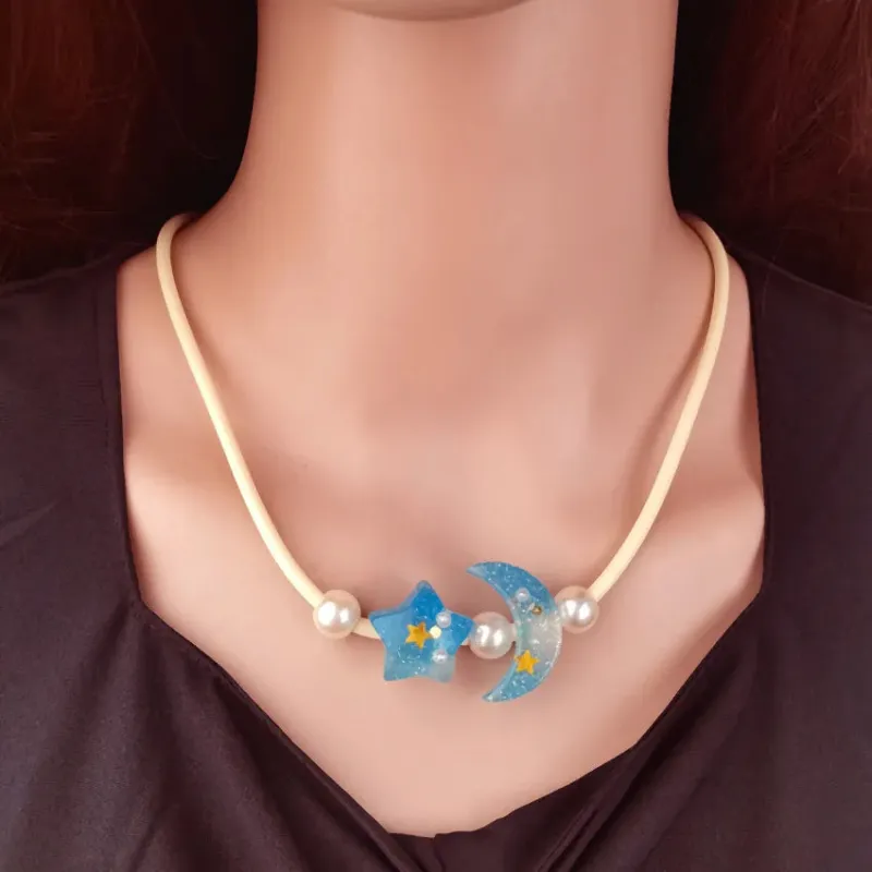 Women's Pendant Necklace Blue Beaded Chain with Star and Moon sold by Hensley London