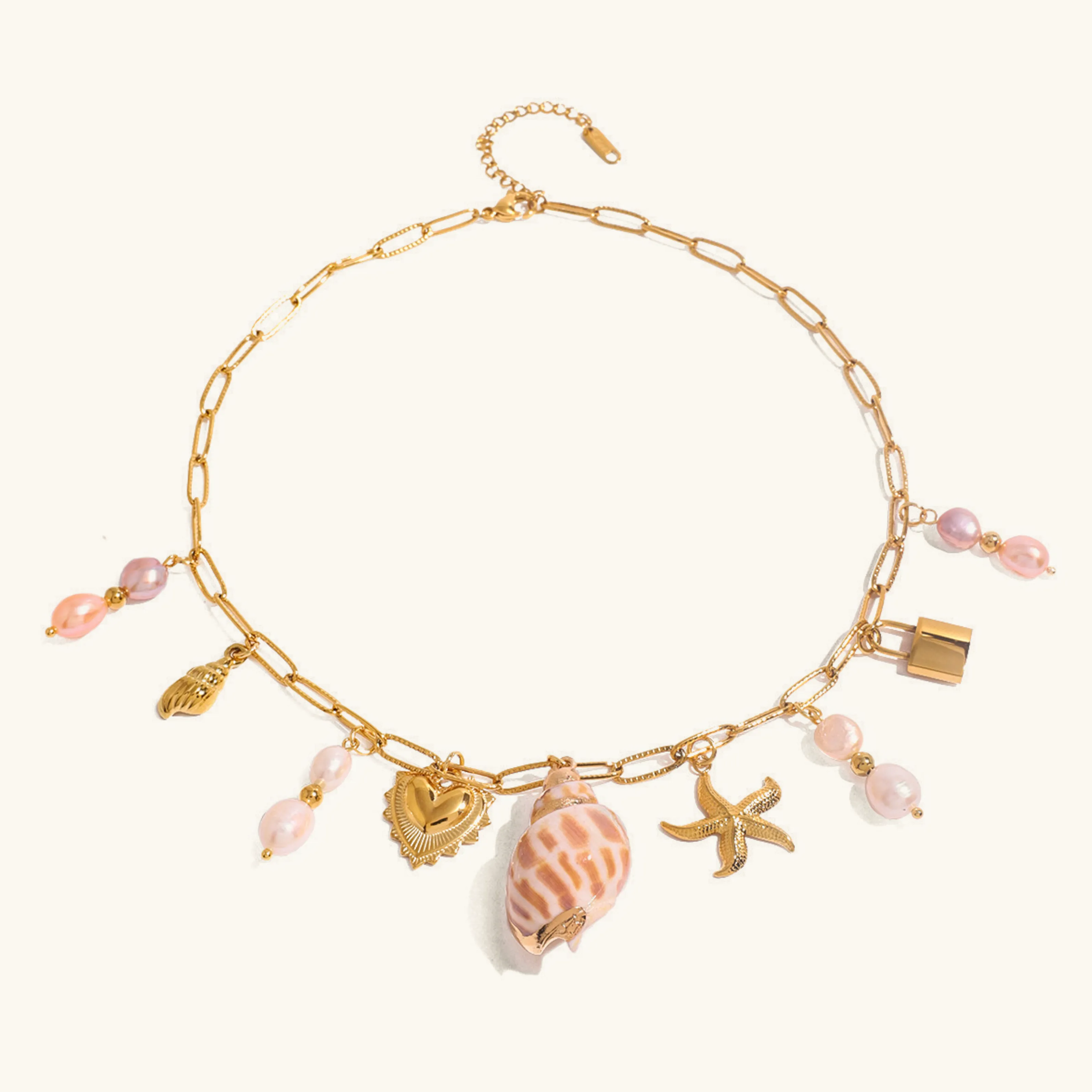 Elegant Gold Freshwater Pearl Necklace with Ocean-Inspired Charms – 16 Inch Adjustable Length sold by Hensley London