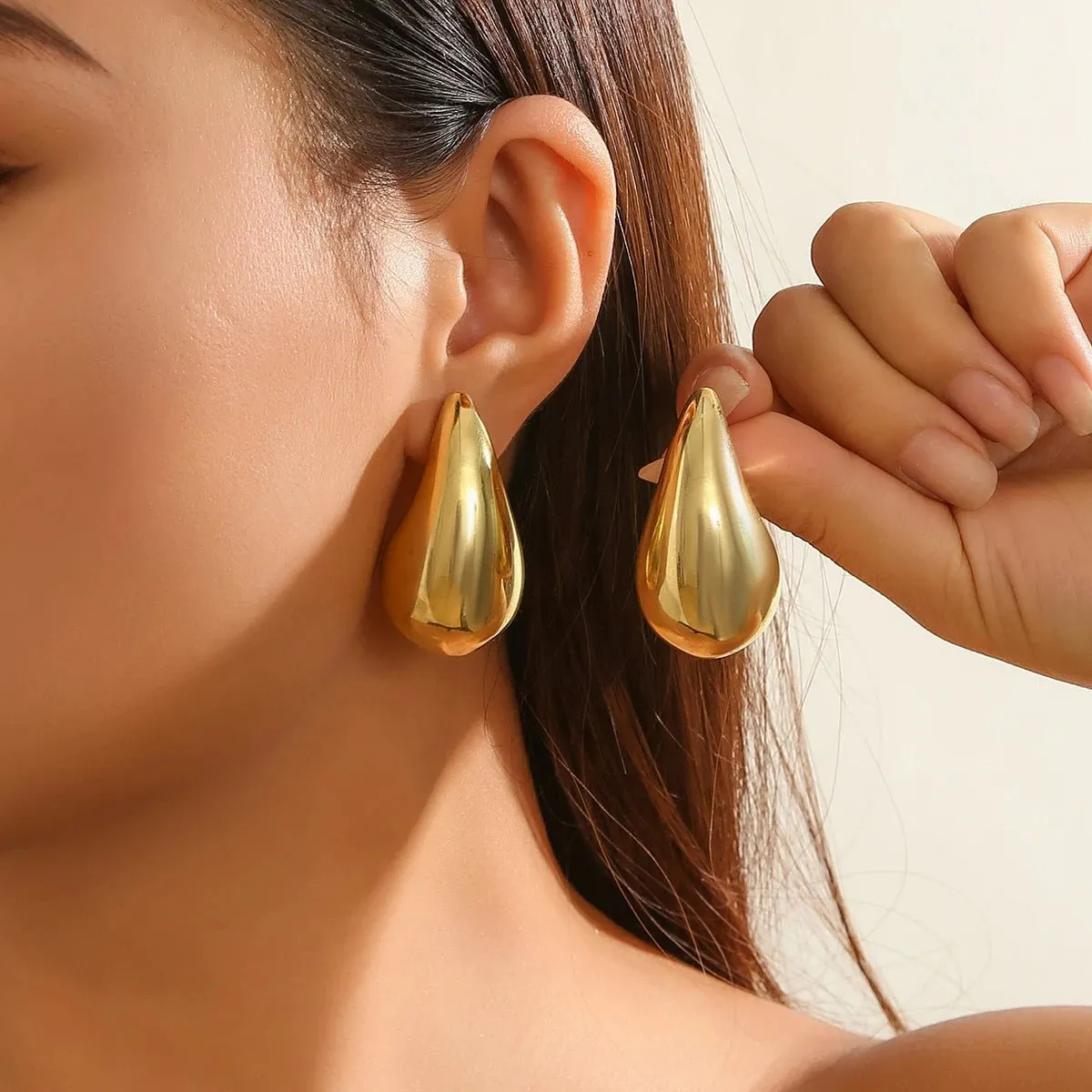 Statement Water Drop Earrings in Gold and Silver – Minimalist Stud Design sold by Hensley London
