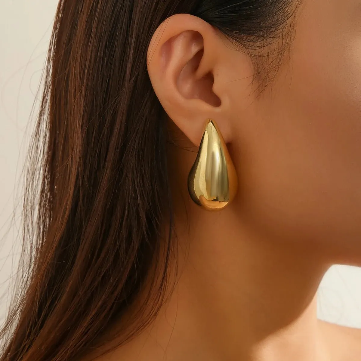 Statement Water Drop Earrings in Gold and Silver – Minimalist Stud Design sold by Hensley London product image thumbnail 2