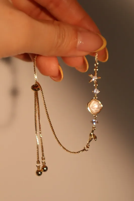 Women's Bracelet Gold Plated Sea Shell Starfish Adjustable sold by Hensley London