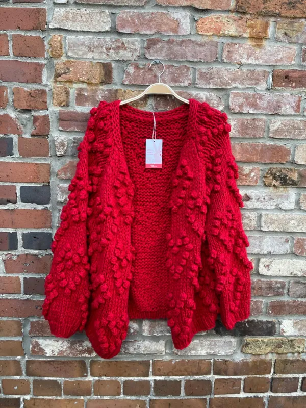 red chunky knit heart pom open cardigan sold by Good Market Thrift Store