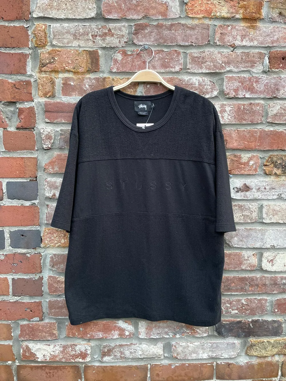 stussy all black minimal fleece tee sold by Good Market Thrift Store