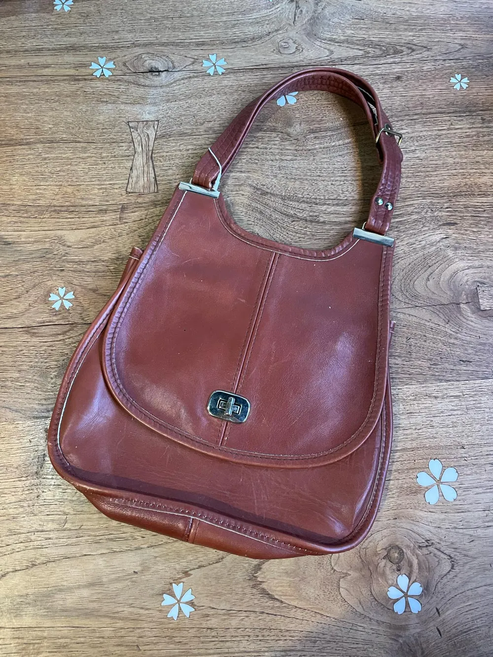 vintage turnlock saddle flap leather handbag sold by Good Market Thrift Store