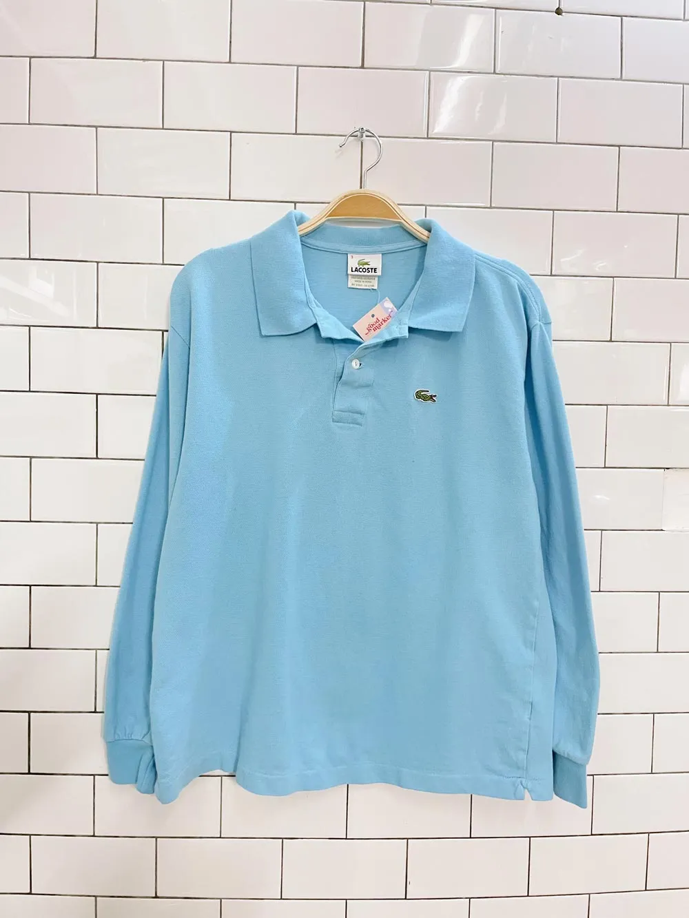 lacoste boxy fit waist length ls polo sold by Good Market Thrift Store