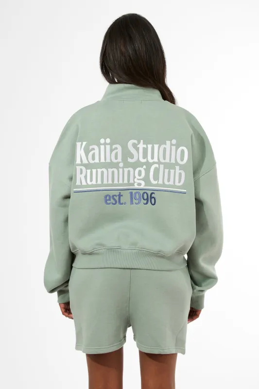 Kaiia Running Club Logo Quarter Zip Sweatshirt Green Tea made by Kaiia the label
