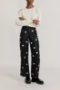 BLACK & WHITE Crepe Flared Pants with Button Details sold by DESTREE