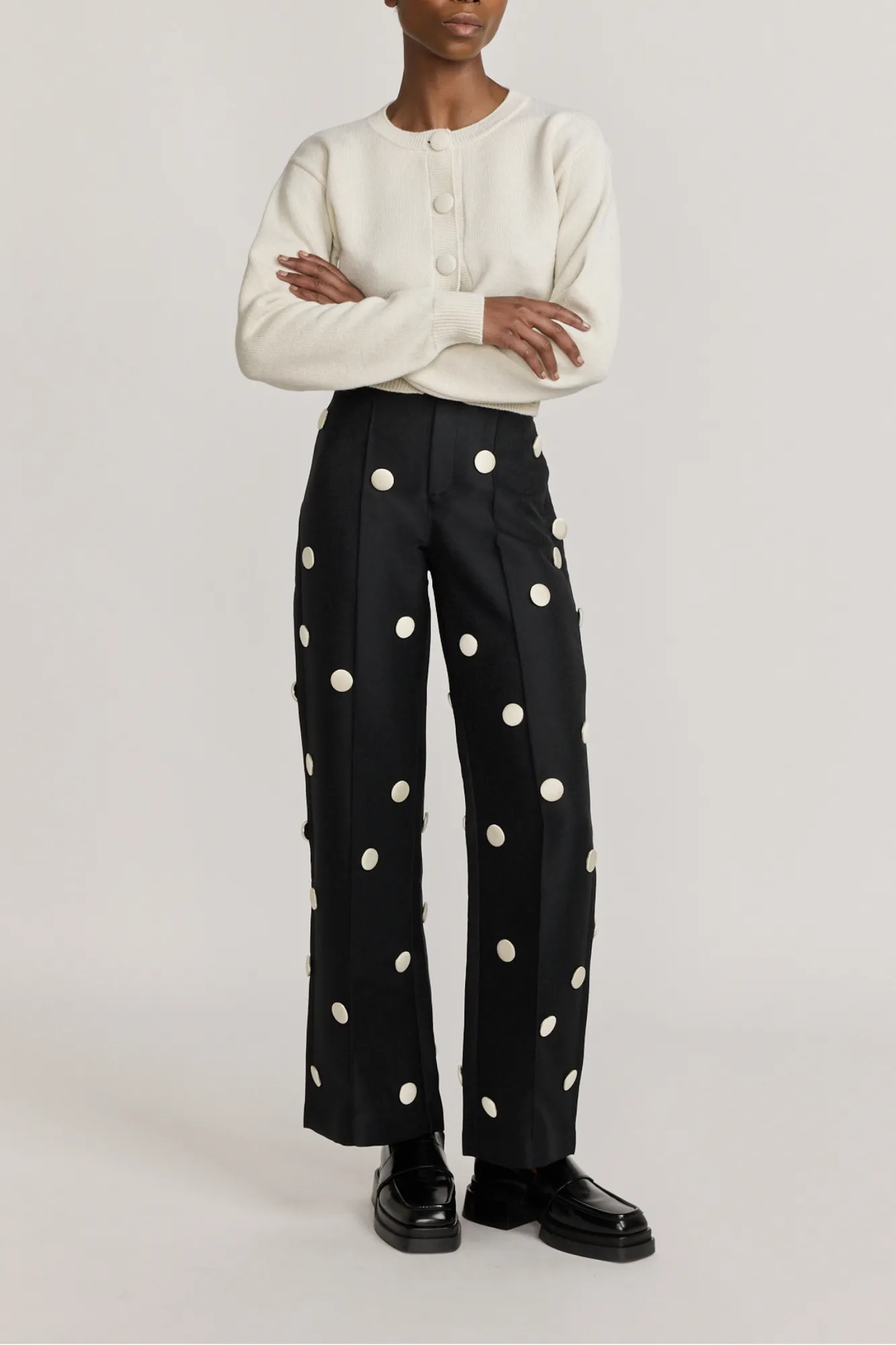 Black & white crepe flared pants with button details sold by DESTREE